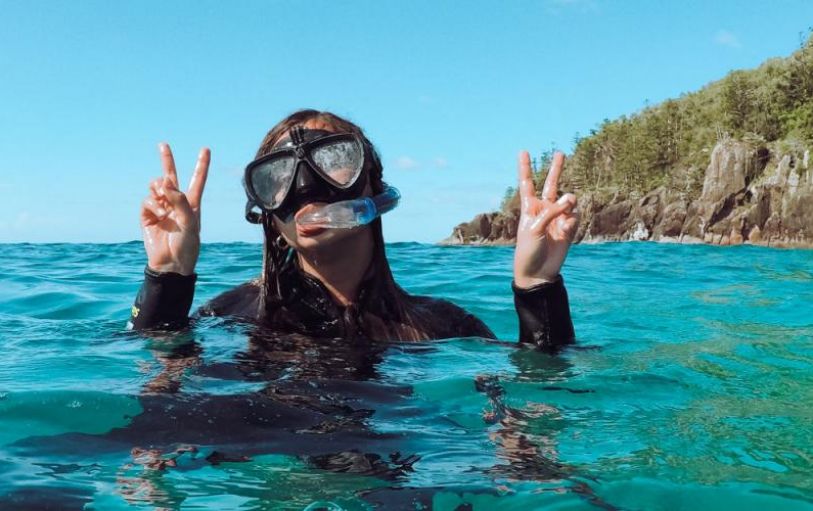 A backpacker swimming in The White sundays Australia