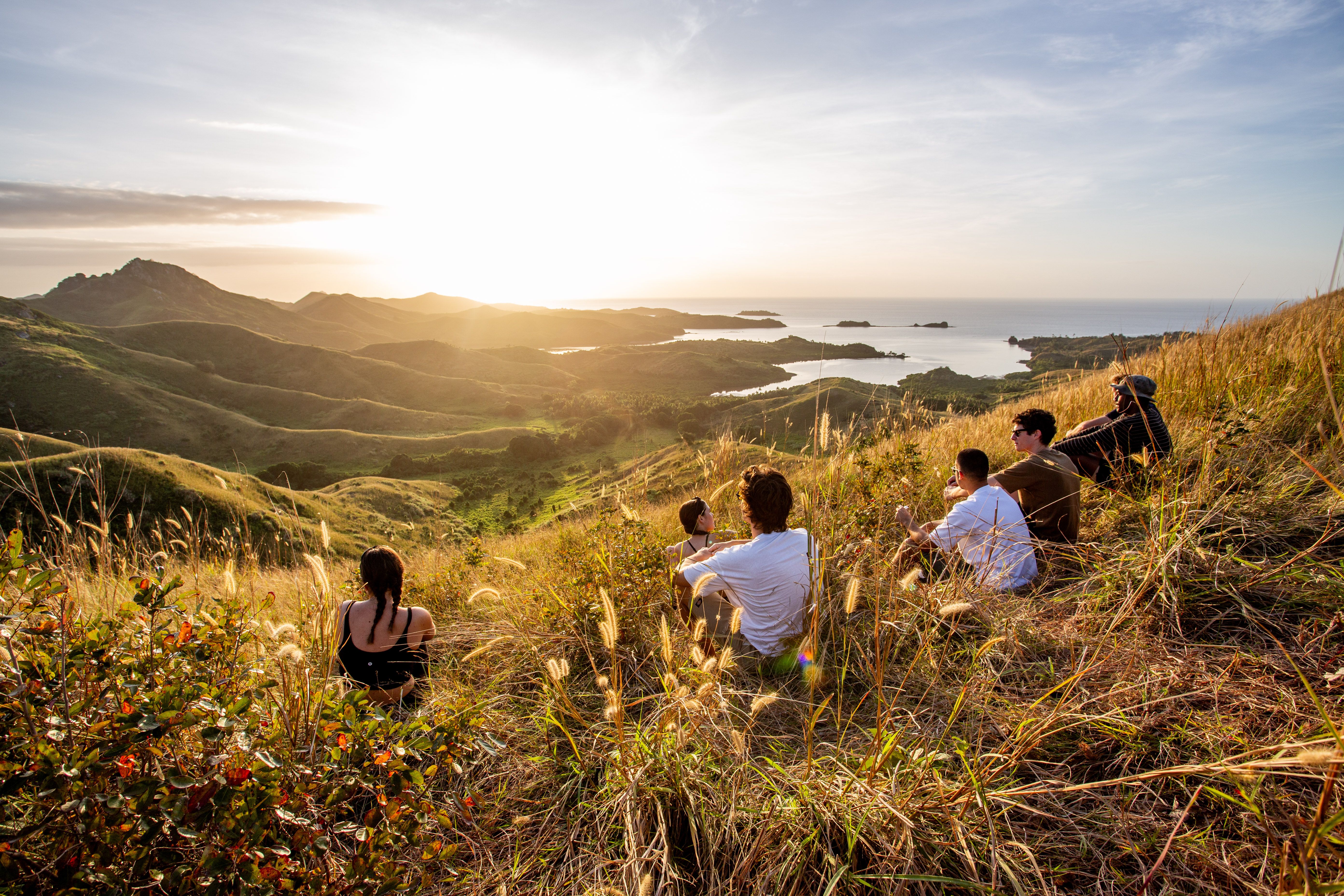 Image of People sitting on mountain looking out at the view in fiji