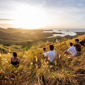 Image of People sitting on mountain looking out at the view