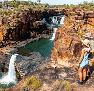 2 travellers are enjoying the falls of Mitchell River in Western Australia