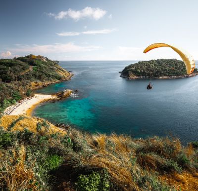 Man paragliding by the beach on the east coast of Australia