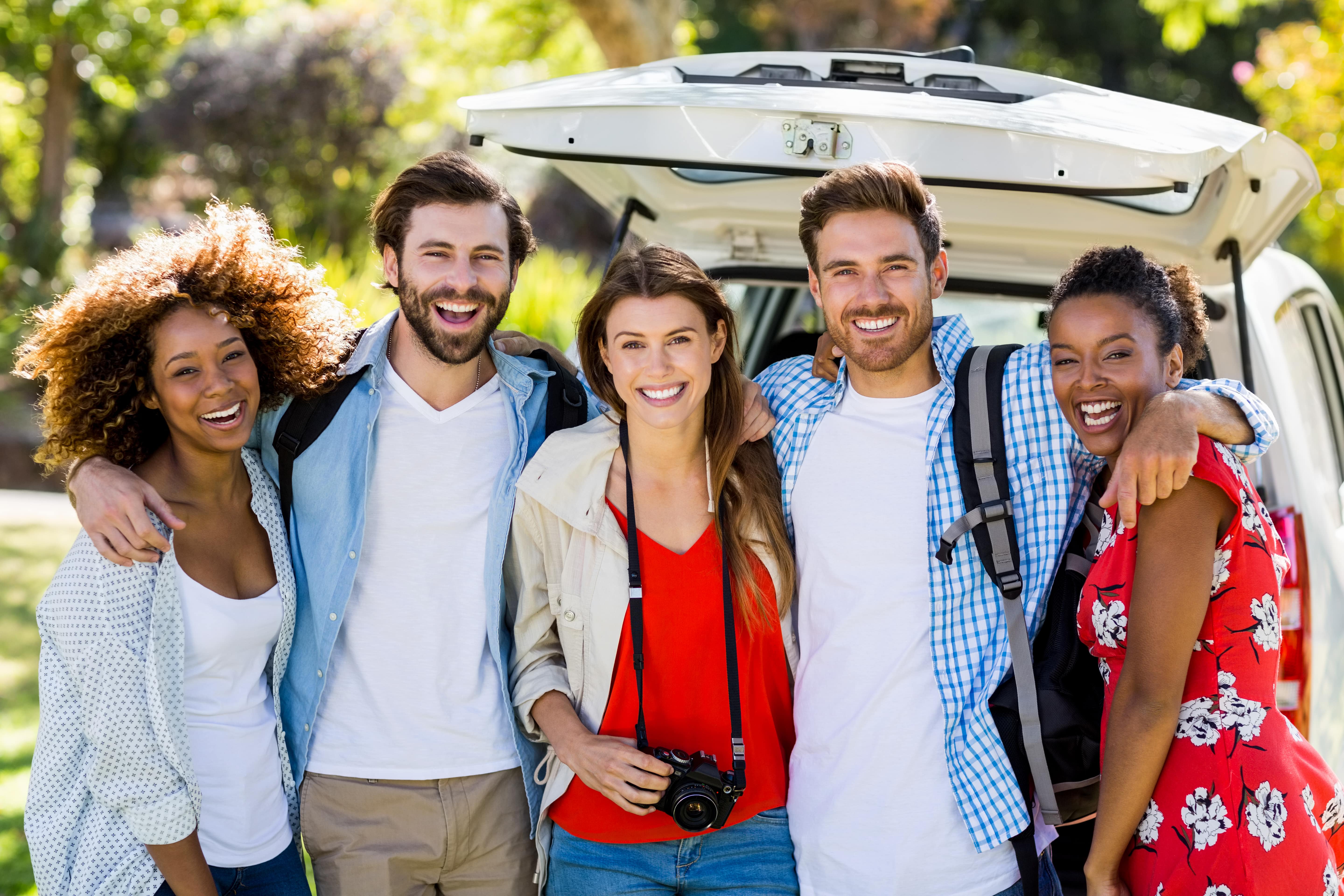 A group of friends standing infront of a car they rented from Peterpans Australi