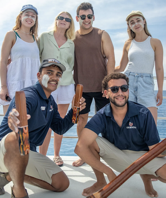 A family on the dreamtime dive and snorkel tour with two indigenous guides