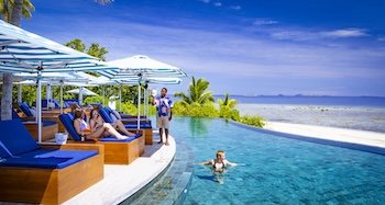 A group of backpackers hanging out and having fun by the pool day beds at Malala Poolside Daybed 